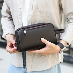 Man holding the FingerLock clutch in Brown
